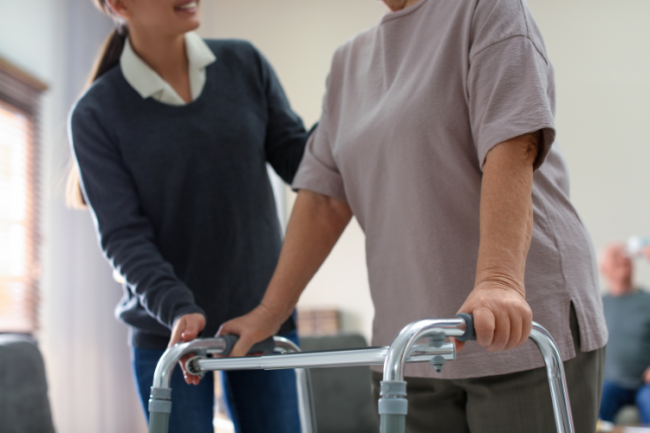 Woman recovering hip surgery with walker