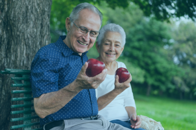 Older couple eating apples