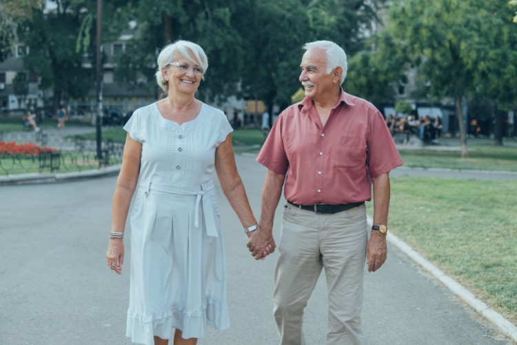 Older happy couple walking
