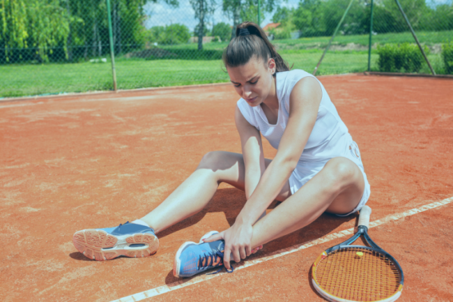Young tennis player with ankle pain