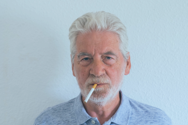 Older man with cigarette in mouth
