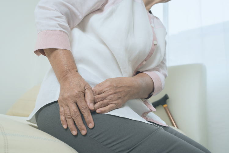 Older woman holding hip from arthritis pain