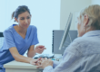 Medical professional sitting with older patient in consultation