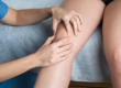 Doctor looking at patient's knee to determine patellar tendonitis