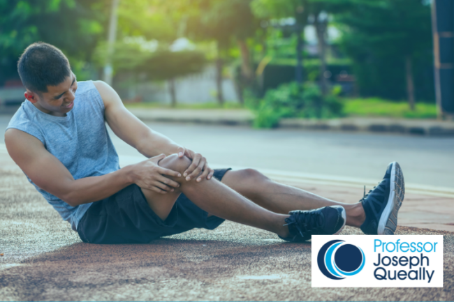 Sports man on ground holding his knee
