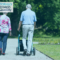 Older people walking with the man pushing a walker