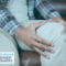 Man sat on sofa holding his knee